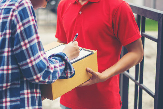 mailman handing over box